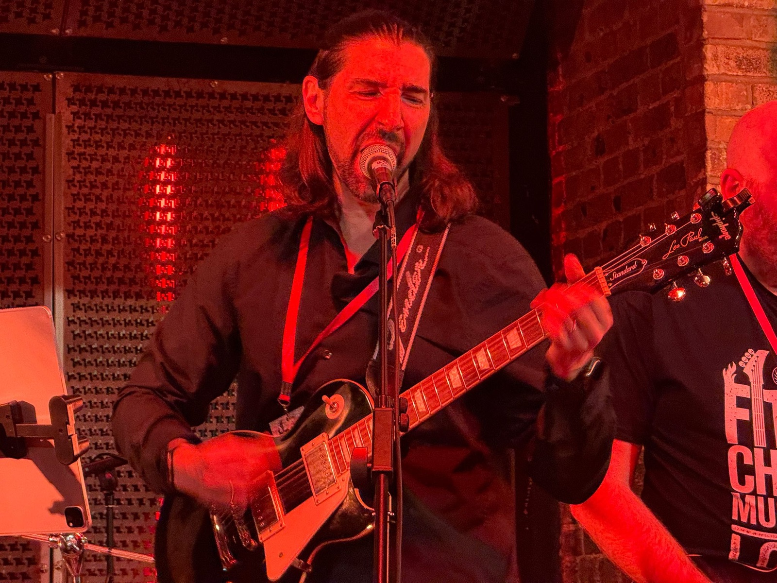 James Garner performing live under red stage lights